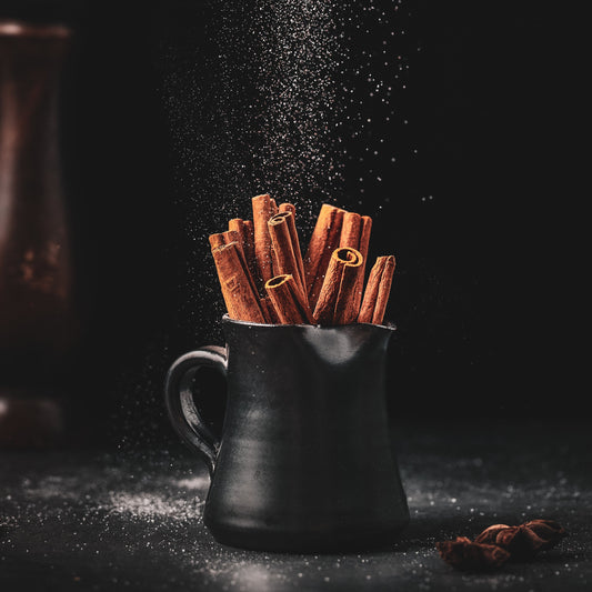 A glowing nighttime campfire under the stars, representing the Midnight Ember package of two single-origin coffees and the Midnight Ember flavored blend.